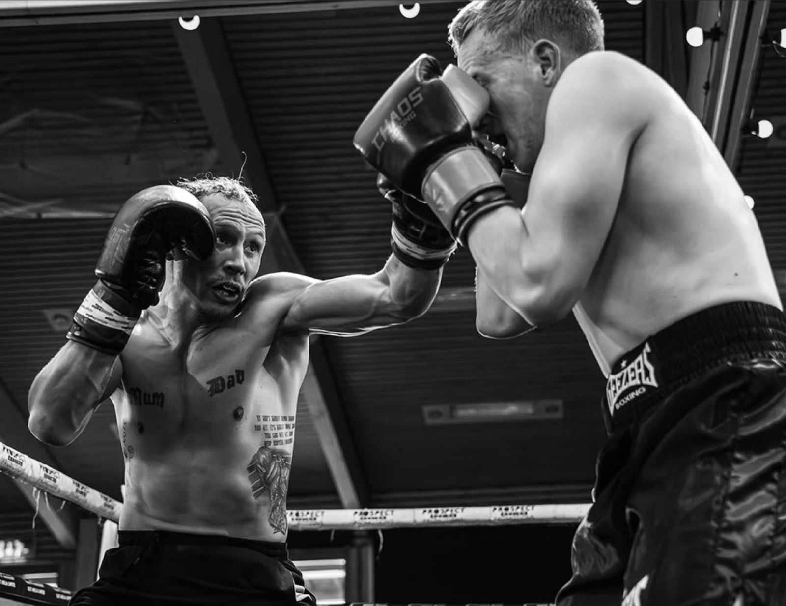 Black and white photo of two boxers trading punches